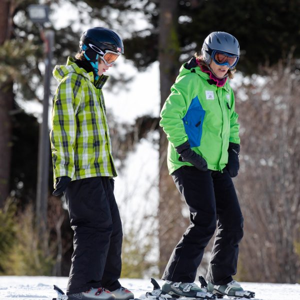 Ski Instructor teaching young skier