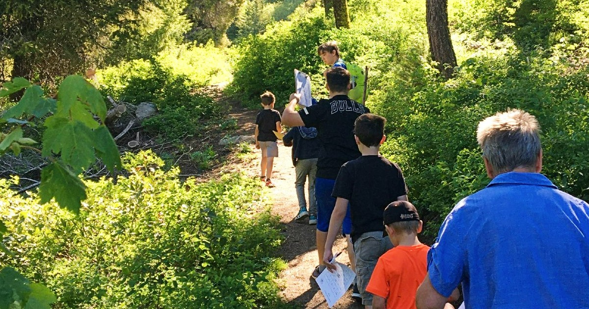 Youth Drop-Off program hiking through the trees along the Bogus Creek trail.