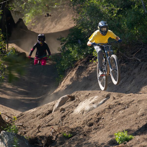 Austin Smith And April Zastrow Riding Over A Rollers Berm Baby Berm Section 1 In The Basin Gravity Park At Bogus Basin Summer 2023