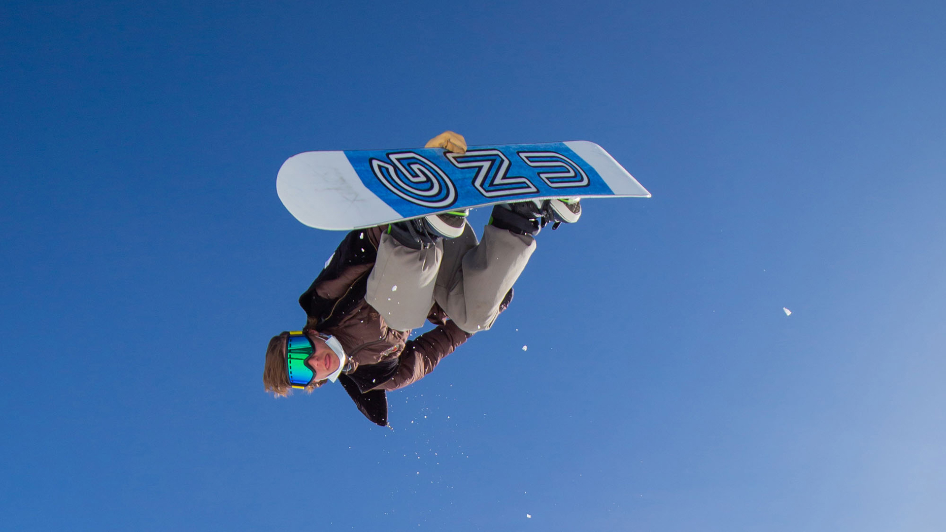 Snowboarder In Mid Air Doing Back Grab Trick With GNU Board And Blue Sky Winter 2022 At Bogus Basin Mountain Recreation Area 1920px1080px