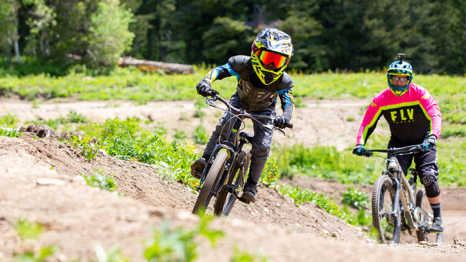 Adult And Child Male Mountain Bikers Close Up In Full Gear Summer At Bogus Basin Mountain Recreation Area 1920px1080px