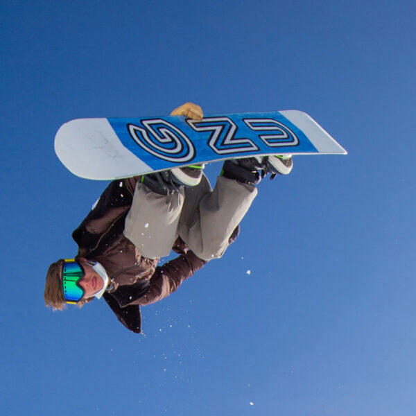 Snowboarder In Mid Air Doing Back Grab Trick With GNU Board And Blue Sky Winter 2022 At Bogus Basin Mountain Recreation Area 1920px1080px