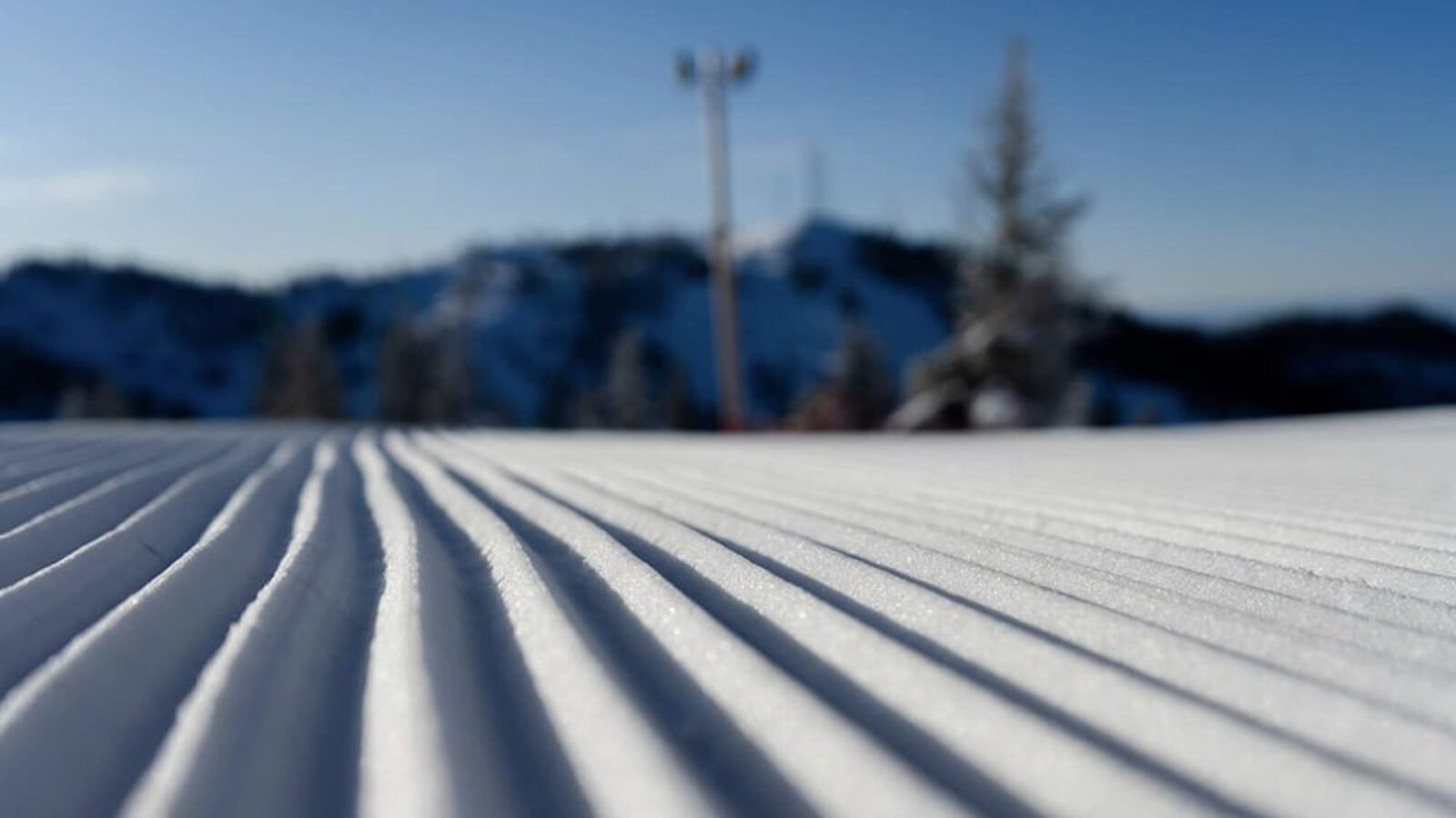 Groomed Run Close Up Corduroy With Light Pole And Towers In Background Blurry Winter At Bogus Basin Mountain Recreation Area 1920px1080px