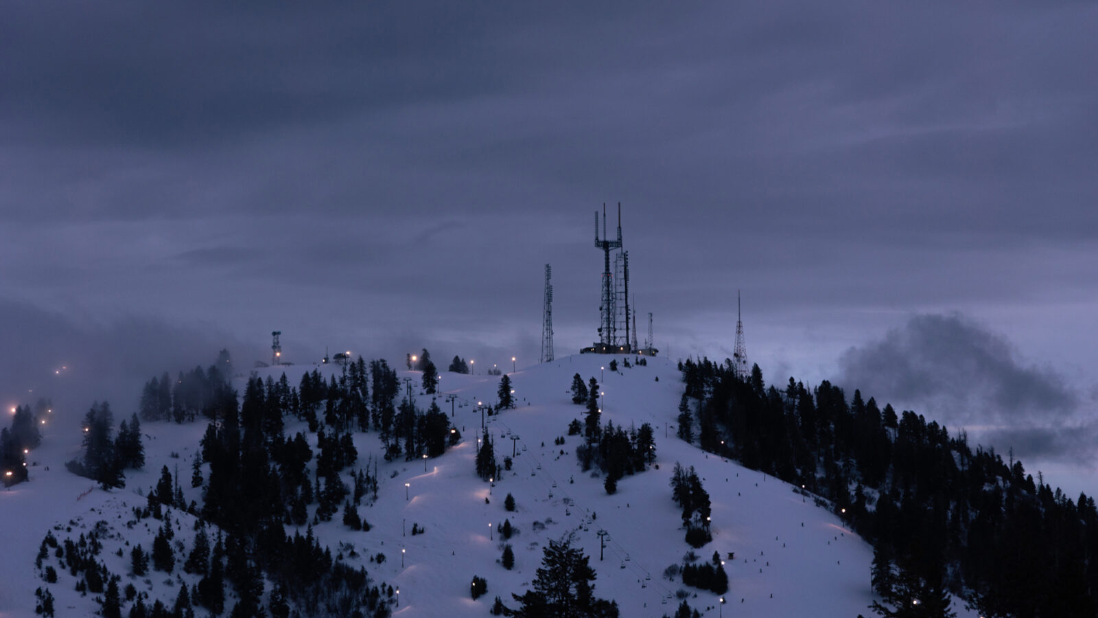 Deer Point Cell Towers At Twilight With Lit Up Runs Night Skiing Operations At Bogus Basin Winter 2024 At Bogus Basin Mountain Recreation Area Photo By Cassidy Carter 1920px1080px