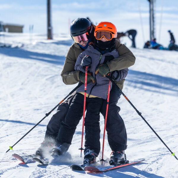Adult Male Jamie Zolber Hugging His Son At The Top Of The Deer Point Express Chairlift While Skiing Winter 2025 At Bogus Basin Mountain Recreation Area Photo By Cassidy Carter 1920px1080px