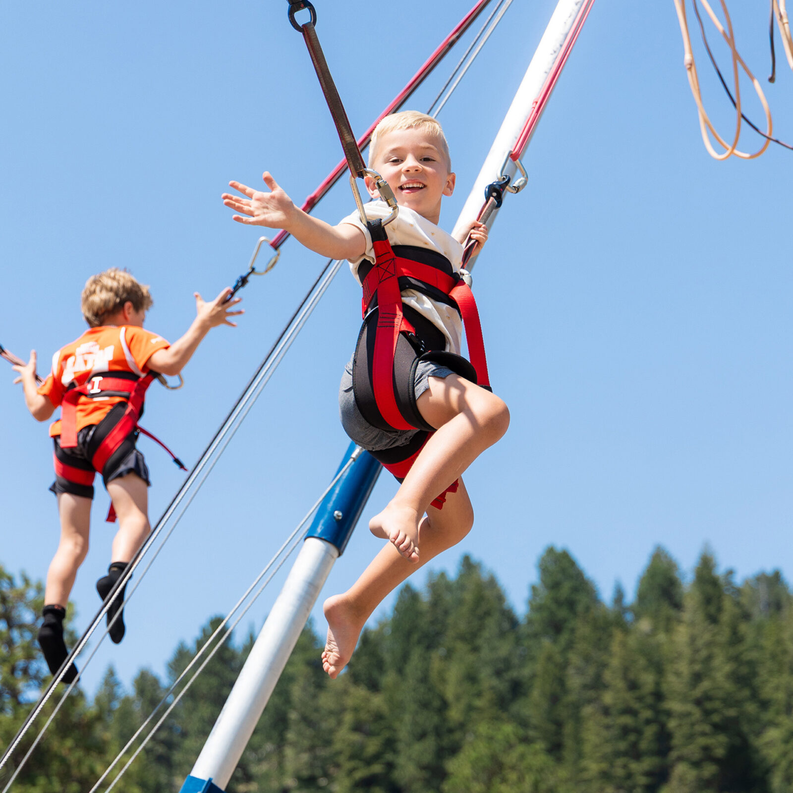 Male Child Smiling And Waving In Air On The Launch Pad Bungee Jump Summer 2025 At Bogus Basin Photo By Cassidy Carter 1920px1920px
